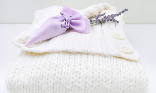 Folded knitted jumper with a small pouch of lavender on top