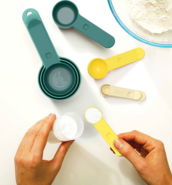 Measuring flour with measuring spoons