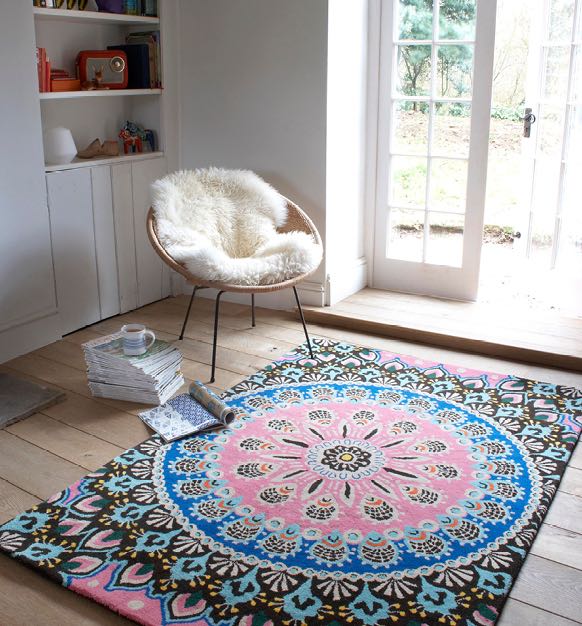 Room with a furry rug and large patterned rug