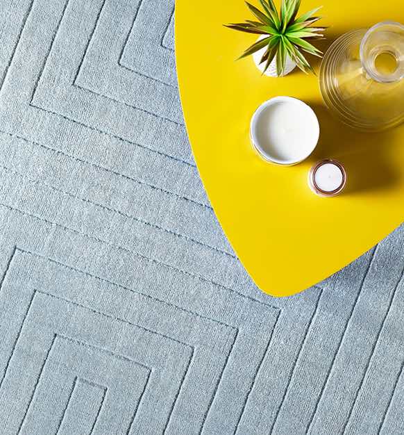 Bright yellow side table with a plant